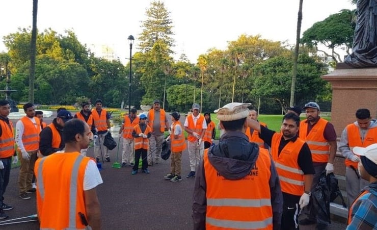 Members of Ahmadiyya Muslim clean the streets following New Year’s eve celebrations
