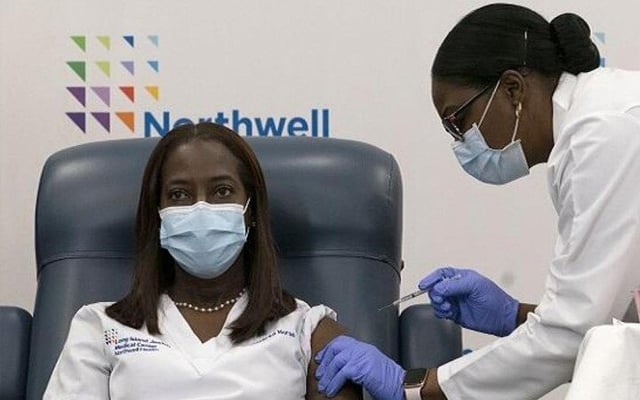 First Covid-19 shots begin on historic day in the US