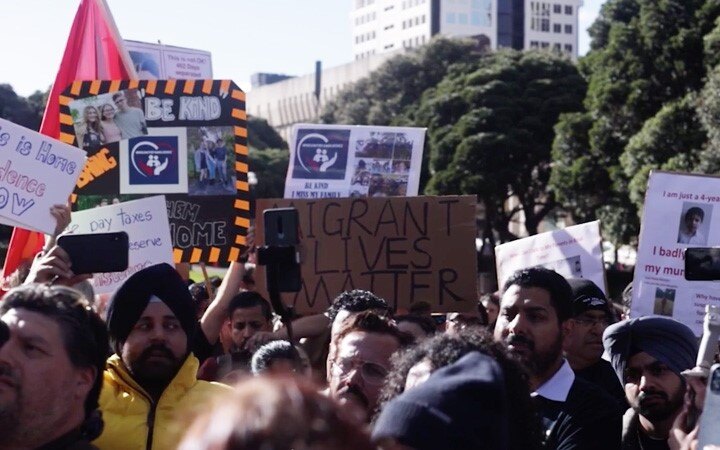 Immigration Minister confronted at rally over border restrictions
