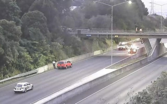 Vehicle crashes through overbridge, dropping to motorway below