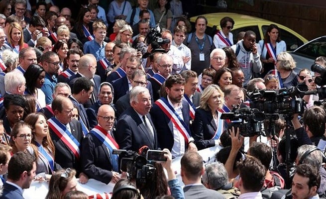 Hundreds march in support of French mayor whose house was attacked by burning car